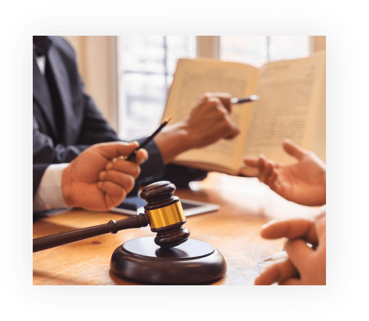 A group of people sitting around a table with papers and a gavel.