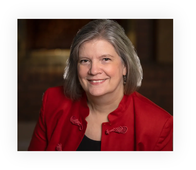 A woman in red jacket smiling for the camera.