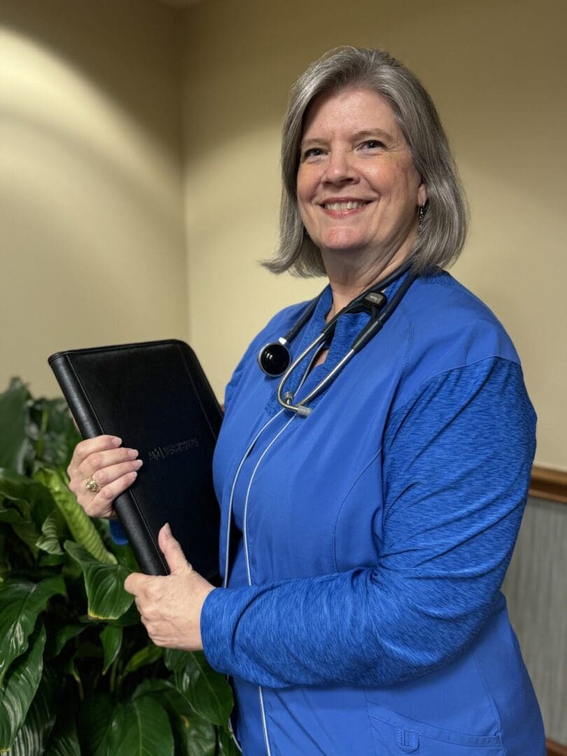 A woman holding a tablet in her hand.